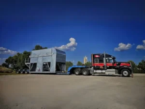 Bowline Logistics coordinates the delivery and crane placement of a prefabricated energy module in the mountains