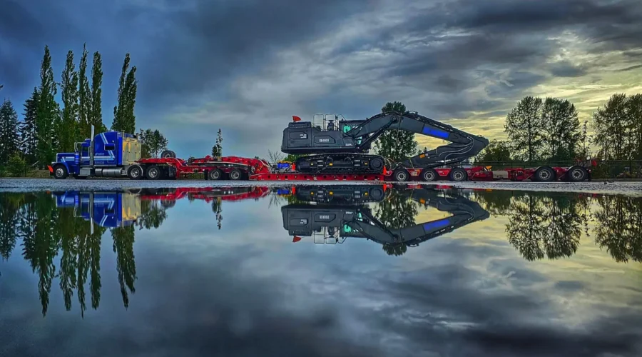 Bowline Logistics truck hauling excavator with reflection Bowline Logistics truck hauling excavator with reflection