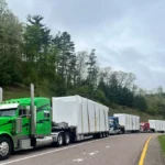Multiple Bowline Logistics trucks hauling containers down the highway