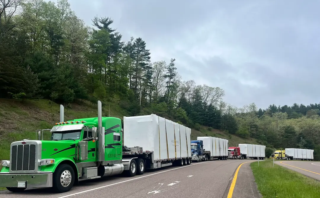 Bowline Reliability and Professionalism Multiple Bowline Logistics trucks hauling containers down the highway