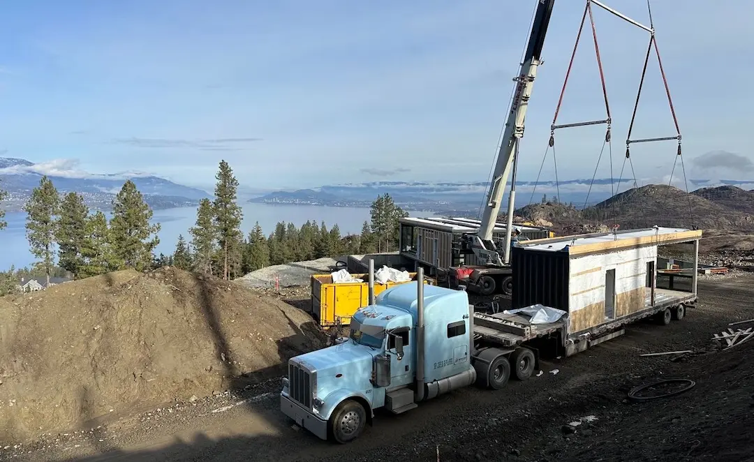 Friendly Fair Service A crane putting freight on the back of a Bowline heavy truck