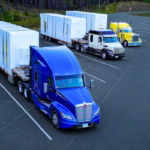 Multiple Bowline Logistics trucks hauling containers down the highway