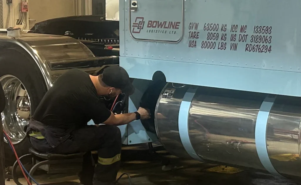 Heavy Truck Technician Working on APU Unit Heavy Truck Technician Working on APU Unit