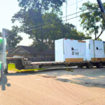 Bowline truck loading large equipment on a trailer in Western Canada.